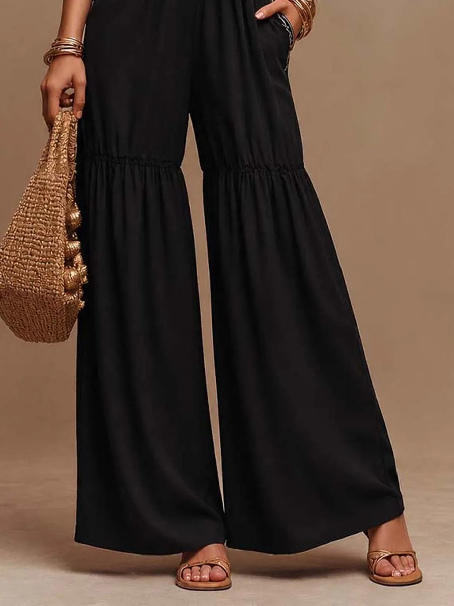Combinaison évasée noire en coton à col halter avec broderie contrastante et étages froncés