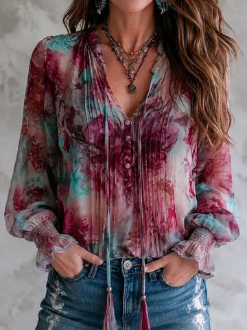 Blusa manga longa com punho franzido, estampa floral boho e amarrações de borla